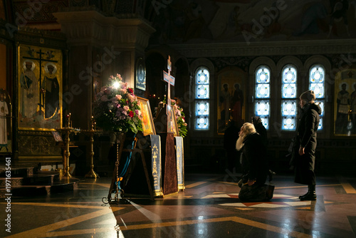 A parishioner praying on his knees in church