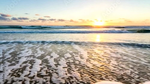Serene sunset over calm ocean waves at the beach