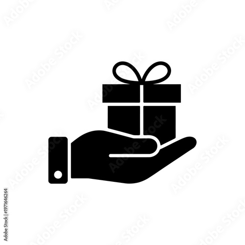 Black hand holding a gift box with ribbon on top  giving a present