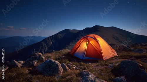 Illuminated Orange Camping Tent on Rocky Terrain