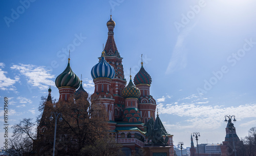 A picturesque view of the Kremlin featuring its iconic golden domes and towers against a vibrant sky, epitomizing the historical and architectural grandeur of Russia.