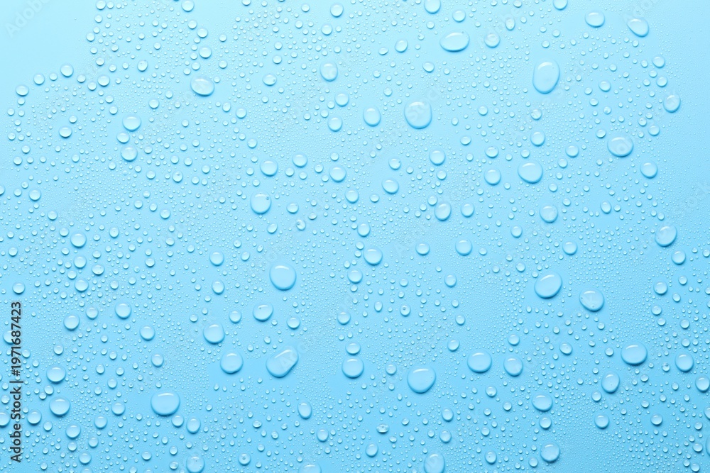 Fototapeta premium Many water drops on light blue background, top view