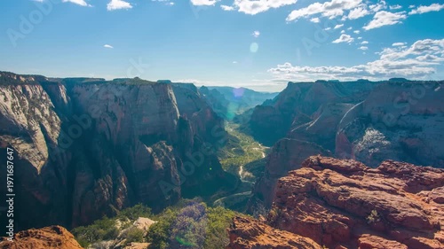 panoramic view of the deep Virgin River valley and the majestic red rock formations of Zion National Park, Utah. The footage captures the expansive landscape as seen from the iconic Observation Point,