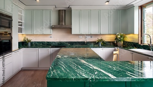 a kitchen with a marble countertop and a green marble island