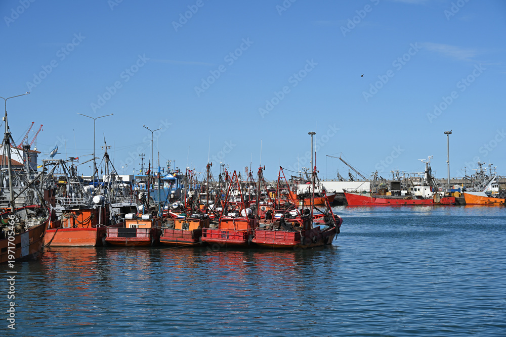 Obraz premium fishing boats in port, construction site with crane