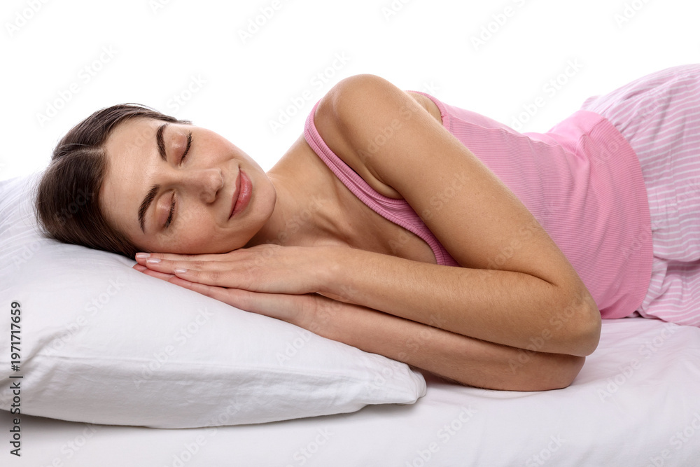 Obraz premium Woman in pajamas sleeping on bed against white background