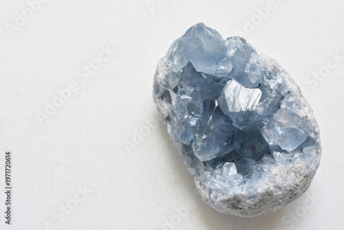 фотографія High-quality image of a natural celestite geode crystal resting on a clean white table