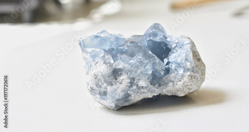 Tableau sur toile High-quality image of a natural celestite geode crystal resting on a clean white table