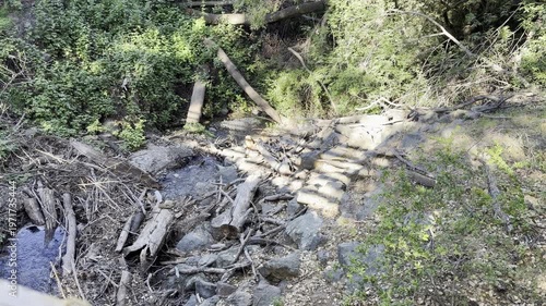 Shadows of hiker and jogger on bridge	