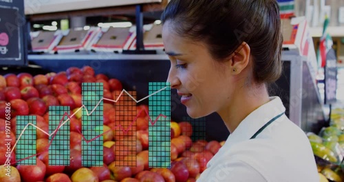 Grocery employee arranging apples in produce, generating bars and lines over apples tracking sales
