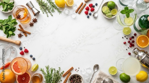 Assorted cocktails, fresh citrus fruits, herbs, and bar tools arranged as a border on a white marble surface for World Cocktail Day celebrations and menu design
