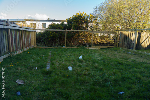 Cuadro en lienzo Messy backyard with broken wooden fence and debris after a storm