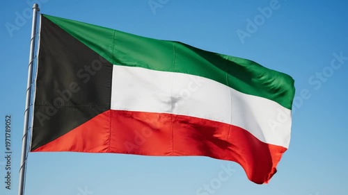 Flag of kuwait waving against clear blue sky, suitable for national pride, cultural events, travel websites, and educational materials.