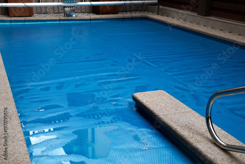 Wallpaper Mural The surface of the pool is covered with a protective coating. Winter season and pool maintenance, pool protection. Selective focus. Torontodigital.ca