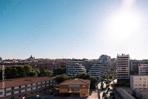 scenic view of modern apartment buildings in Arganzuela District , traditional residential blocks, and lush green trees in Madrid, Spain
