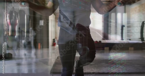 Man swinging rope, starting quick footwork, revealing torso, creating layered gym glow for cardio