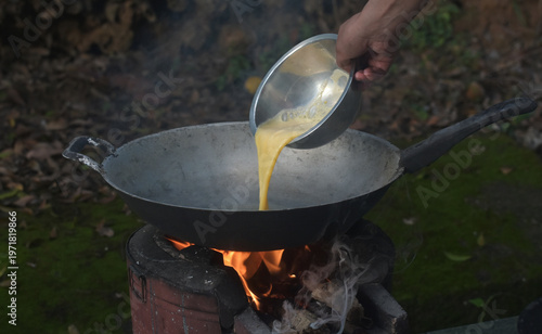 Omelette. I'm frying an omelette over a natural wood-fired stove.