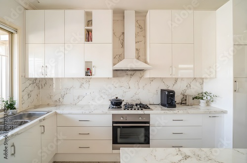 Modern kitchen with white marble tiles on one wall