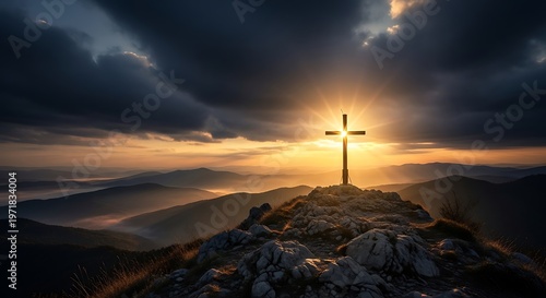 Christian cross standing on a rocky mountain peak at sunset with dramatic storm clouds and bright sun rays glowing behind the wooden crucifix