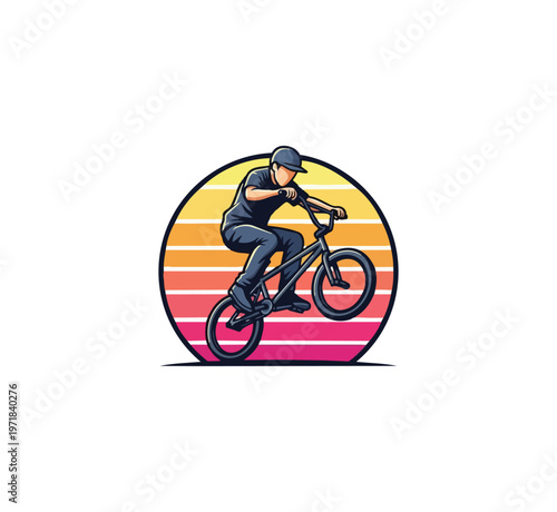 Bmx rider silhouette performing wheelie against sunset circle