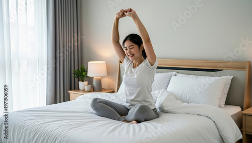 Morning Stretch: A woman starts her day in serene tranquility, stretching gently on a cozy bed, bathed in the soft morning light.