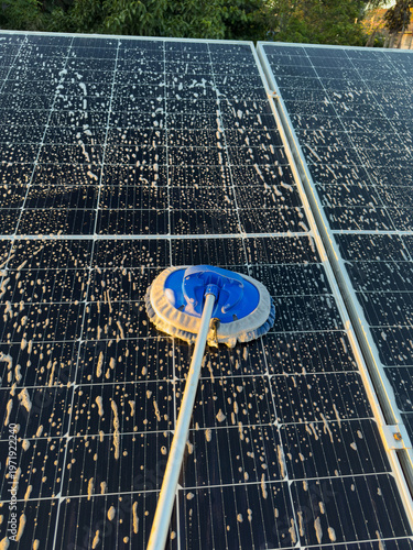 Cleaning solar panels on a sunny afternoon for better energy output