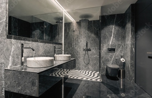 A luxury bathroom with freestanding tub, marble finishes, and dramatic black feature wall