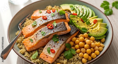Delicious salmon bowl with avocado and chickpeas on a white table