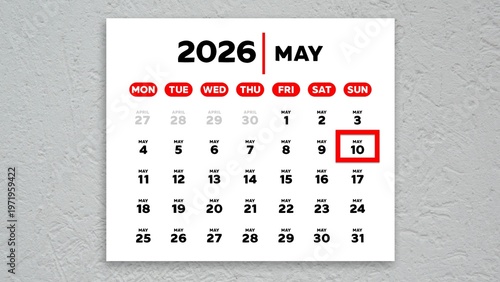 The date May 10th marked with a red cursor on a wall calendar 2026