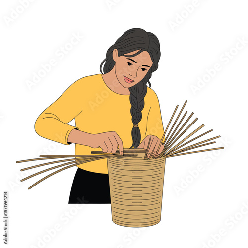 A woman weaves with slender reeds into a woven basket demonstrating craft