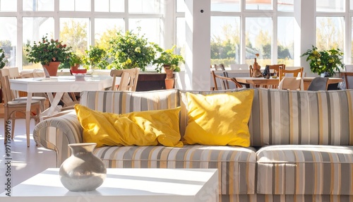Bright, airy interior with sofa, yellow pillows, dining, plants