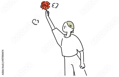 はたきで埃をはらう掃除中の女性