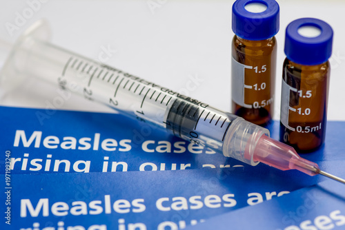 Tableau sur toile A measles outbreak and vaccination concept with a macro closeup of information l