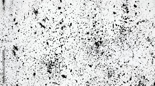Black splatters on a white background create a dynamic vector graphic illustration with a mix of small and large dots and irregular shapes scattered across the surface