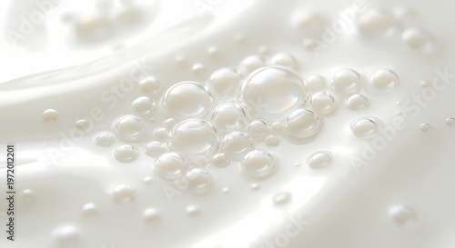 White liquid surface with numerous bubbles of various sizes clustered together. 