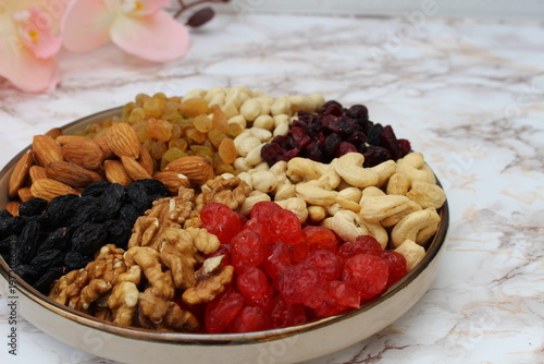a mixture of nuts and dried fruits on the table in a plate