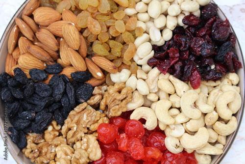 a mixture of nuts and dried fruits on the table in a plate