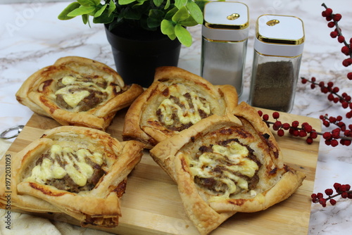 There are puff pastry pies on the table