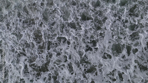 Aerial View of Ocean Waves with Foamy White Water Texture Background