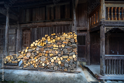 Ancient house with firewood for fireplace at Shuangfeng Village of Tujia ethnic group in Xiangxi, China, a village that still maintains a traditional lifestyle