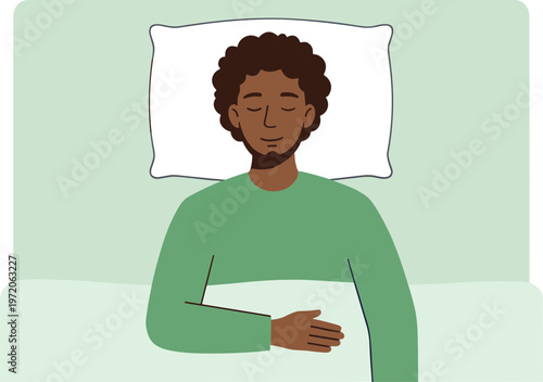 A man sleeps peacefully on a bed with a pillow under his head and a blanket covering his body