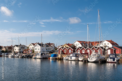 Marina with moored boats and waterfront buildings in Källö-Knippla harbor, northern Gothenburg archipelago, Bohuslän, west coast Sweden