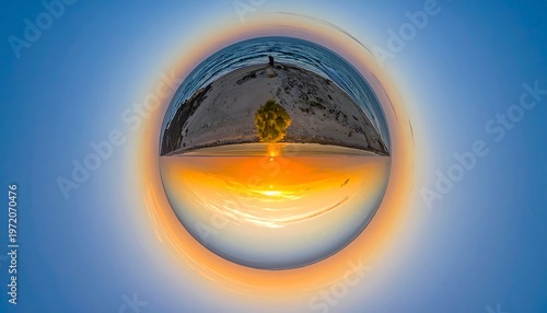 A spherical view of a sunset over a serene landscape