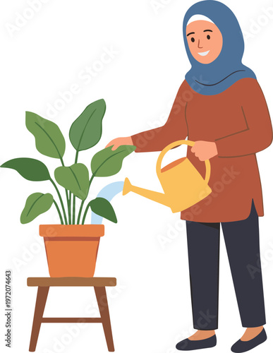 Woman wearing hijab waters large green plant in terracotta pot on stool indoors