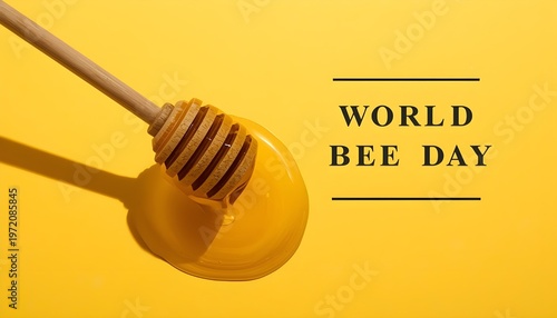 A honey dipper with honey on a yellow background celebrating World Bee Day