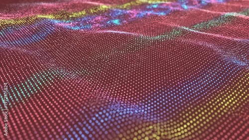Abstract digital mesh of glowing multicolored particles on a coral red background. Geometric grid of dots forms a dynamic wave-like topographical surface with a shallow depth of field.