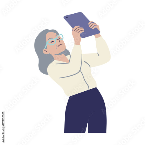 An elderly woman takes a photo with her tablet outdoors.