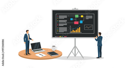 Two professional businessmen in dark suits present complex data on a large digital screen next to a round wooden meeting table with a laptop and coffee.
