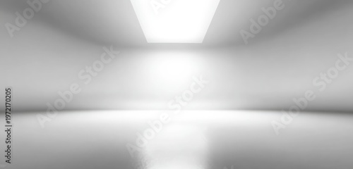 Minimalist white studio interior with bright light from ceiling and floor reflection.