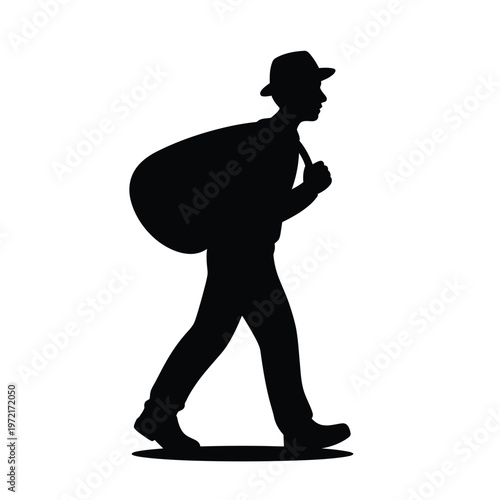 Silhouette of a man walking with a large bag over his shoulder